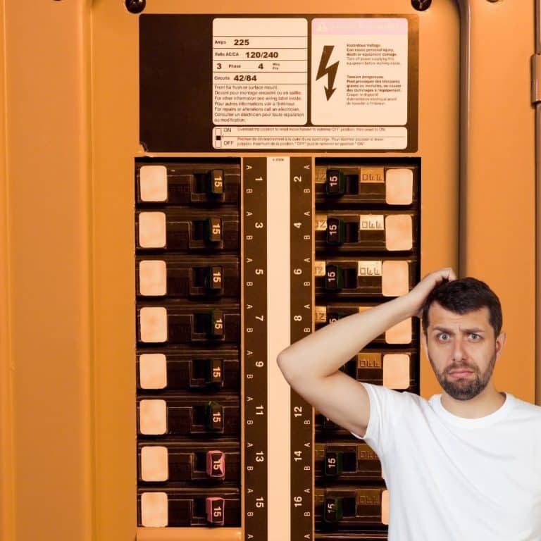 Man in t-shirt worried face electrical panel in background